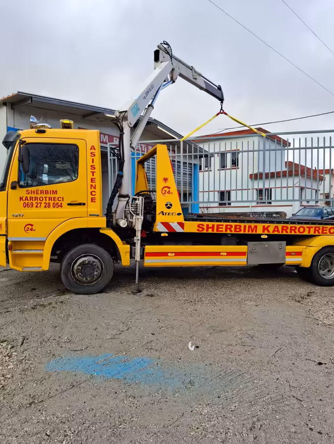 Tow truck crane lifting cargo at the yard