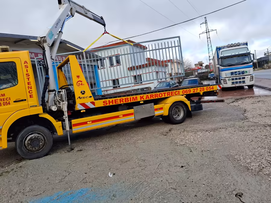 Empty flatbed tow truck parked at the yard, ready for dispatch