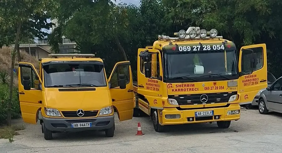 Karrotrec Rigelsi tow truck and van parked side by side at base, doors open
